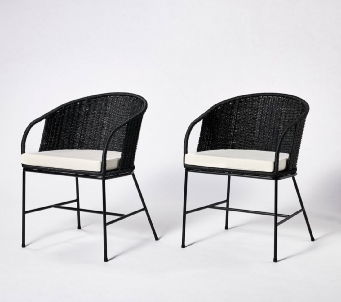Pair of black woven barrel dining chairs with cushions