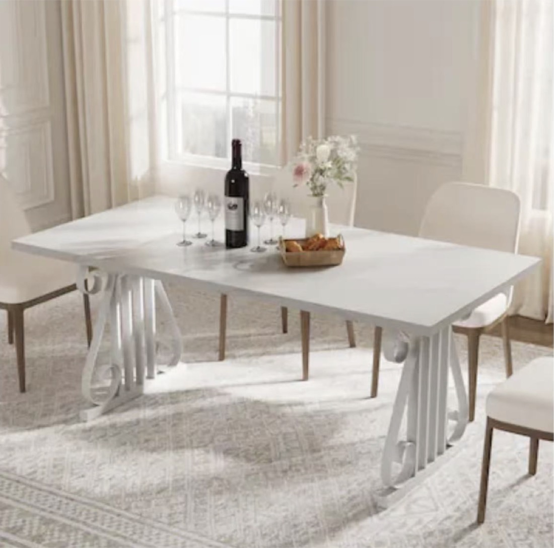 White faux-marble top dining table with pedestal base and cream chairs