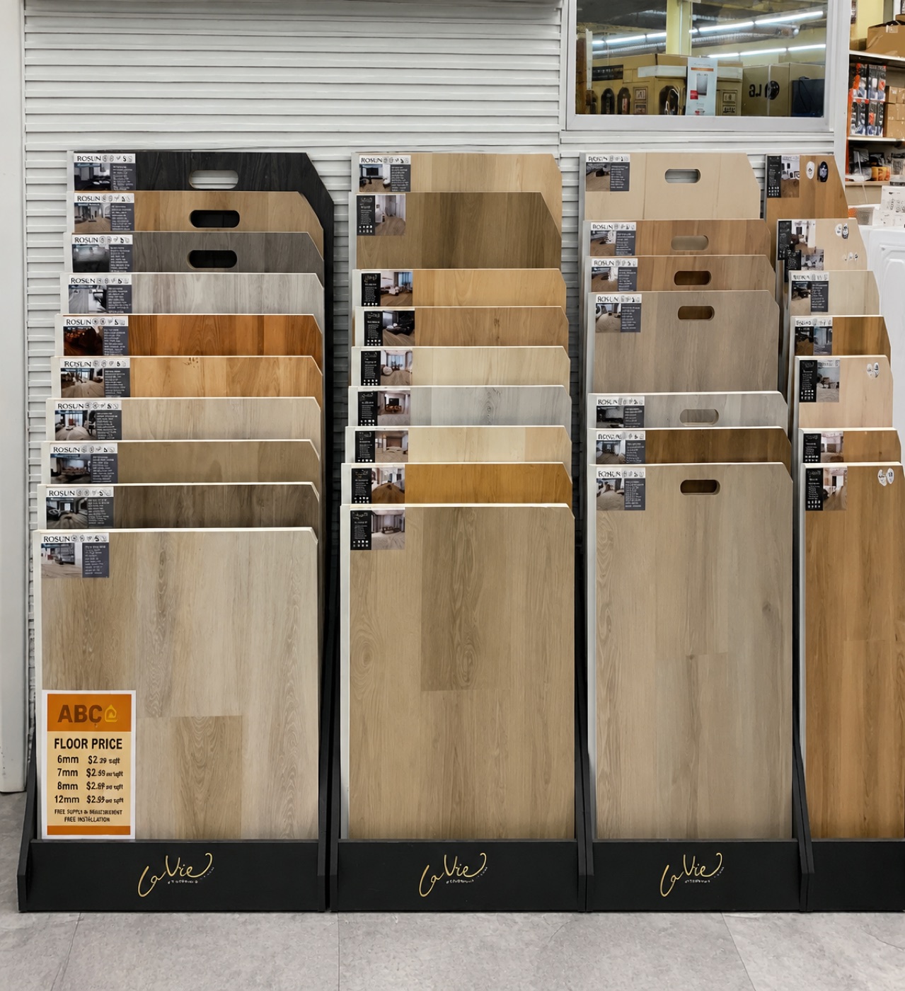 ABC Home Outlet vinyl plank flooring display with floor-price sign listing per-square-foot pricing