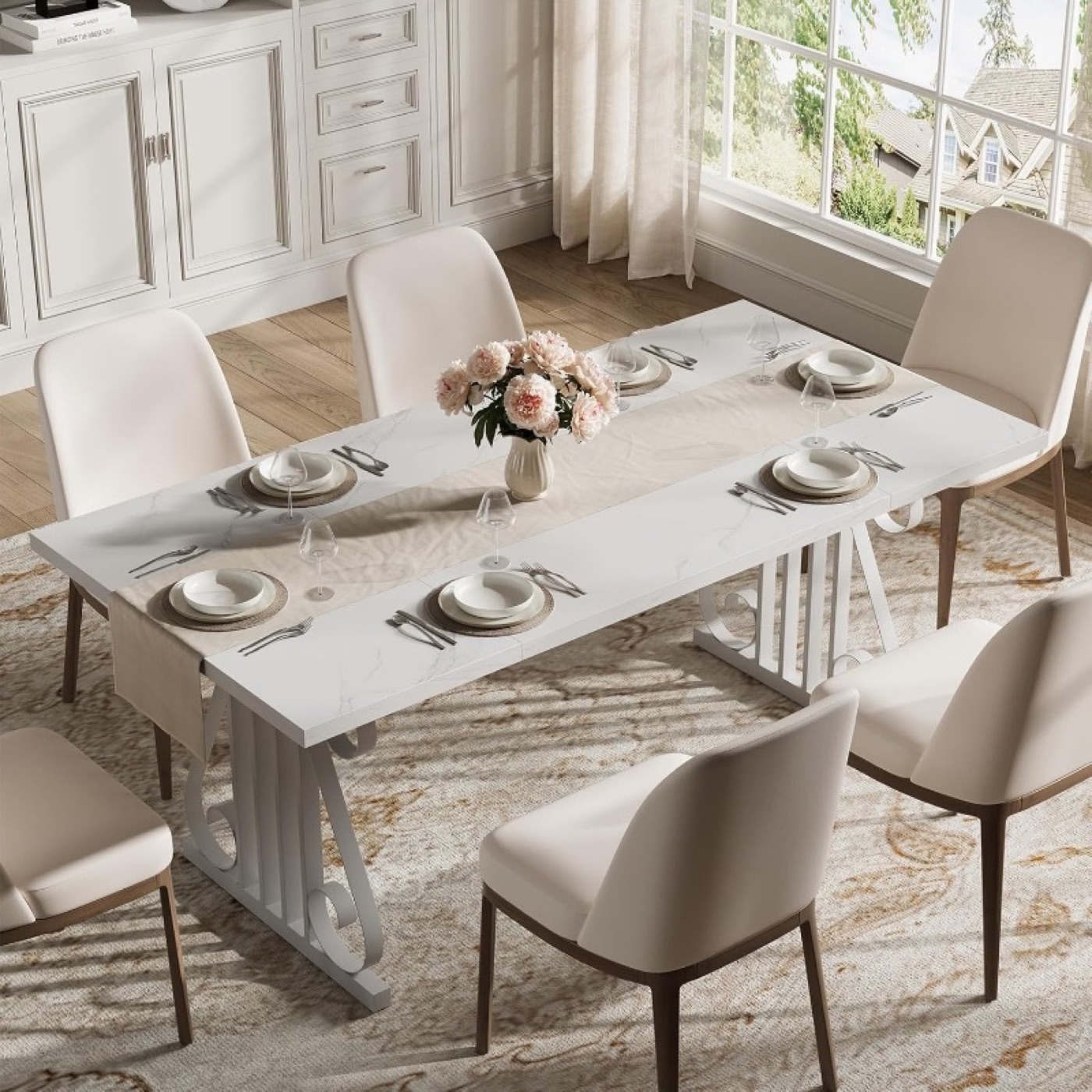 White faux-marble top dining table with six cream upholstered chairs in a styled dining room