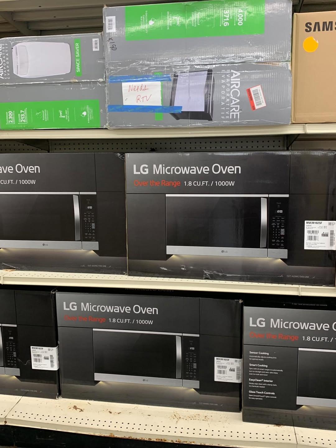 LG over-the-range microwave ovens in shelf display