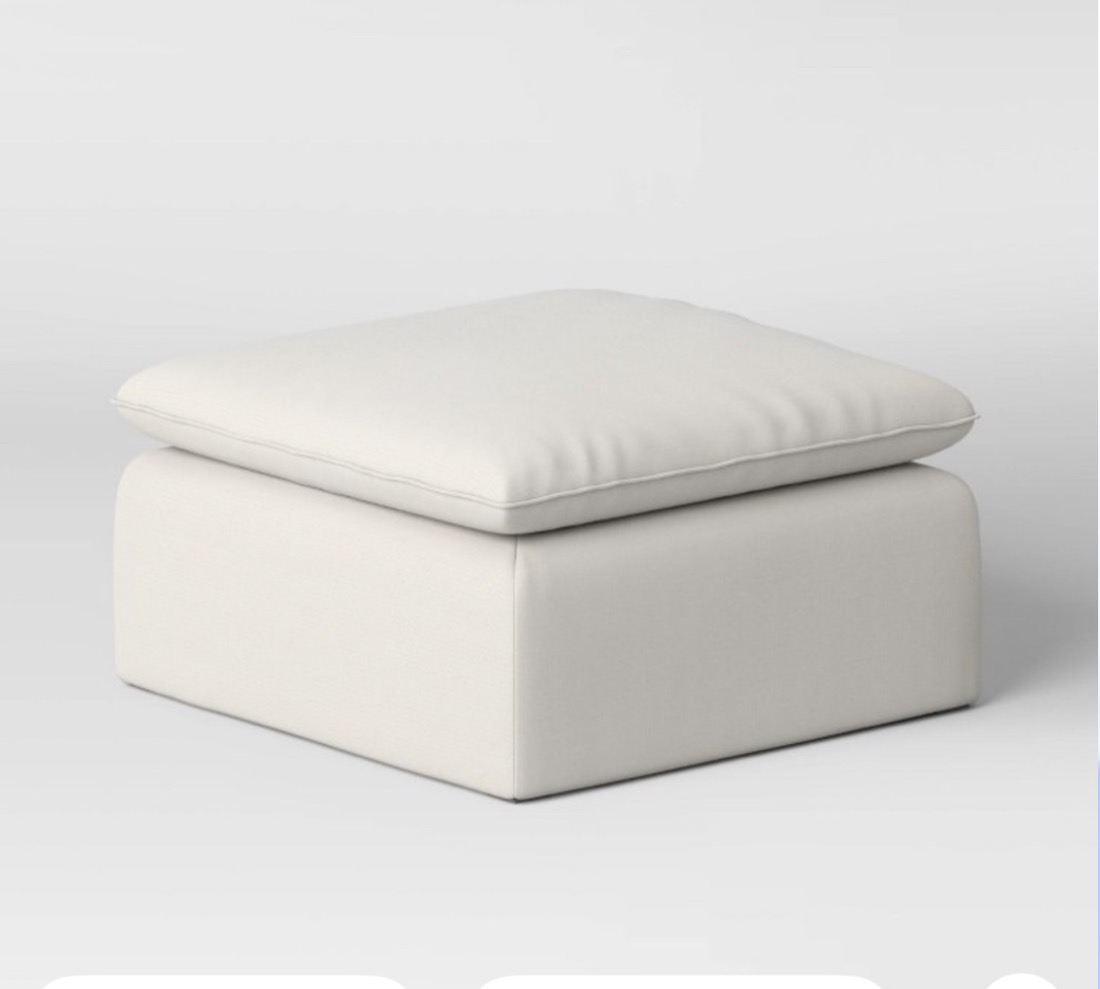 Cream upholstered cube ottoman with plush cushioned top