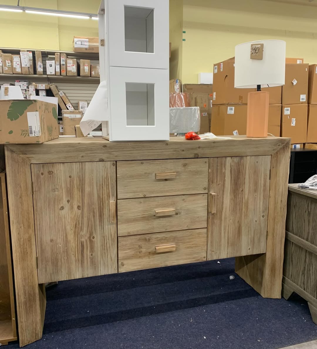 Wooden sideboard with table lamp